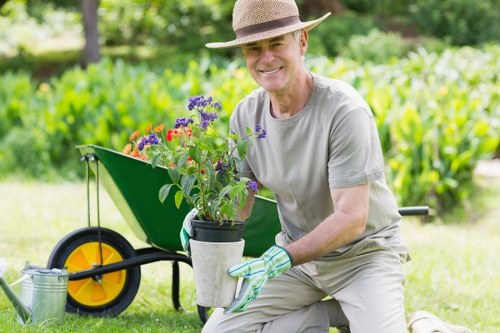 Garden clearance in progress with workers removing green waste in a suburban plot